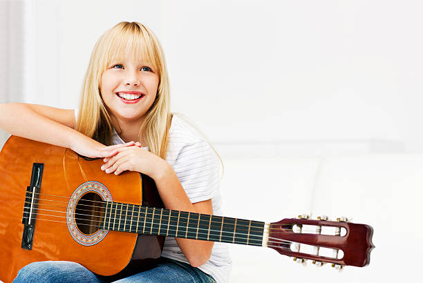 istock Young Girl Holding Guitar 534782335