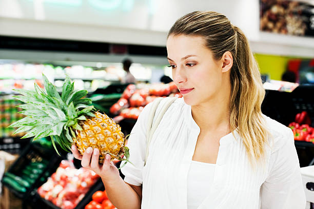 istock Woman Looking at Fruit 534782347