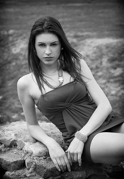 istock Attractive young woman in grassland leaning on stone 534783673