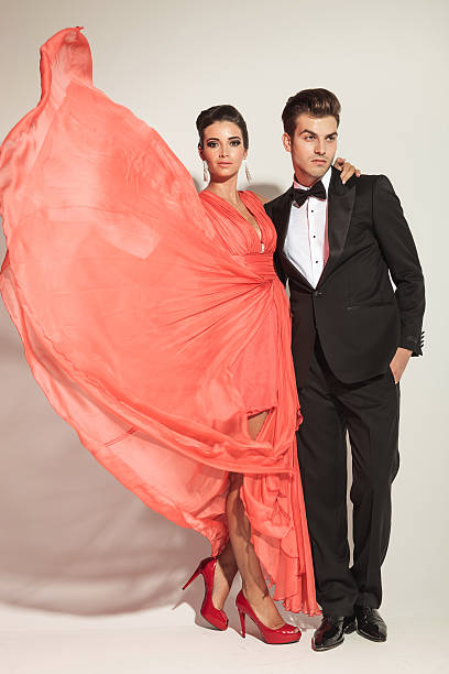 istock young fashion couple posing on grey studio background 534784553