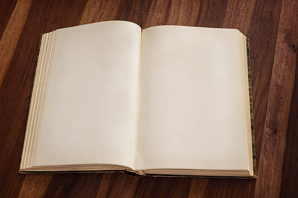 istock Open blank old book wooden background 534786071