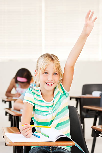 istock Pretty school raising hand to answer 534786623