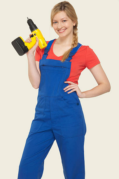 istock Young woman holding power drill smiling 534787147