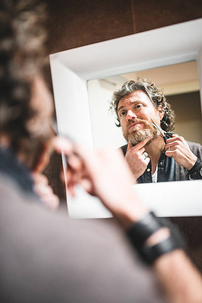 istock cutting the beard in front of mirror 534788159