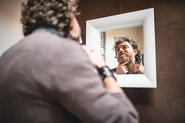istock cutting the beard in front of mirror 534788161