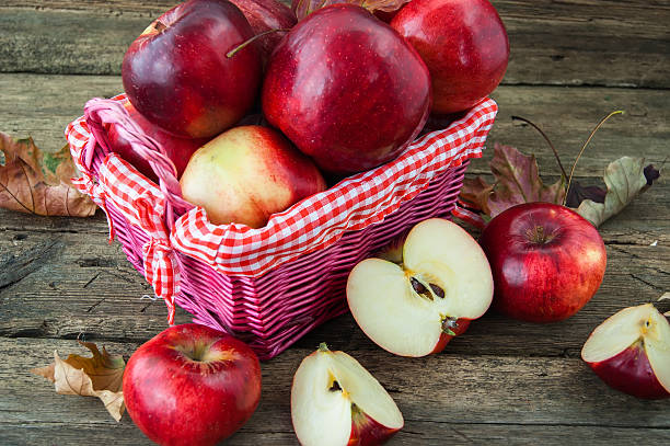 istock red apples in a basket on wooden background 534788219