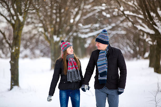 istock loving couple walking in winter park 534788297