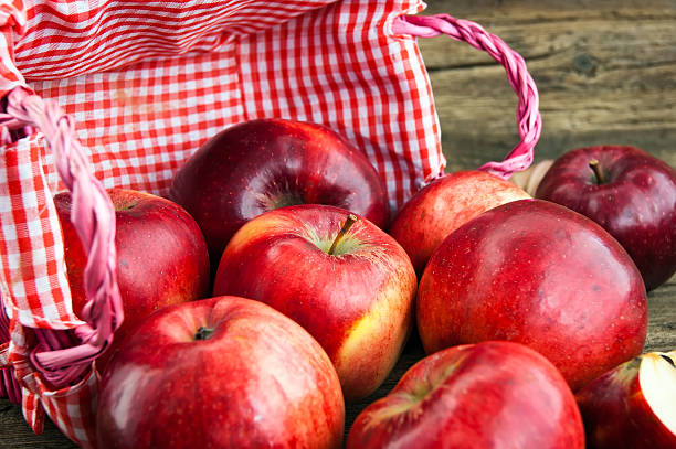 istock red apples in a basket on wooden background 534788303