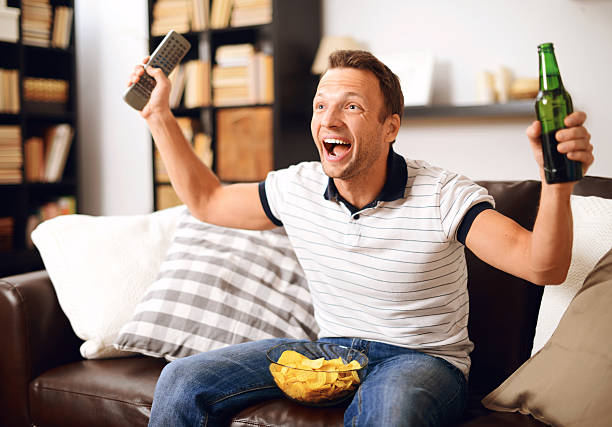 istock man looking sports on TV 534788969