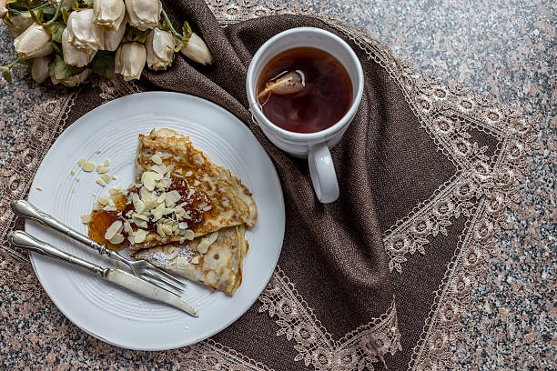 istock Pancake with cup of tea on table cloth 534798407