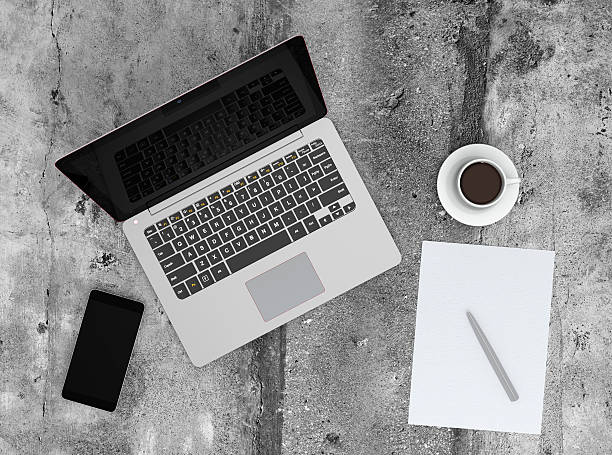 istock Smart phone, laptop and coffee cup on concrete ground 534798829