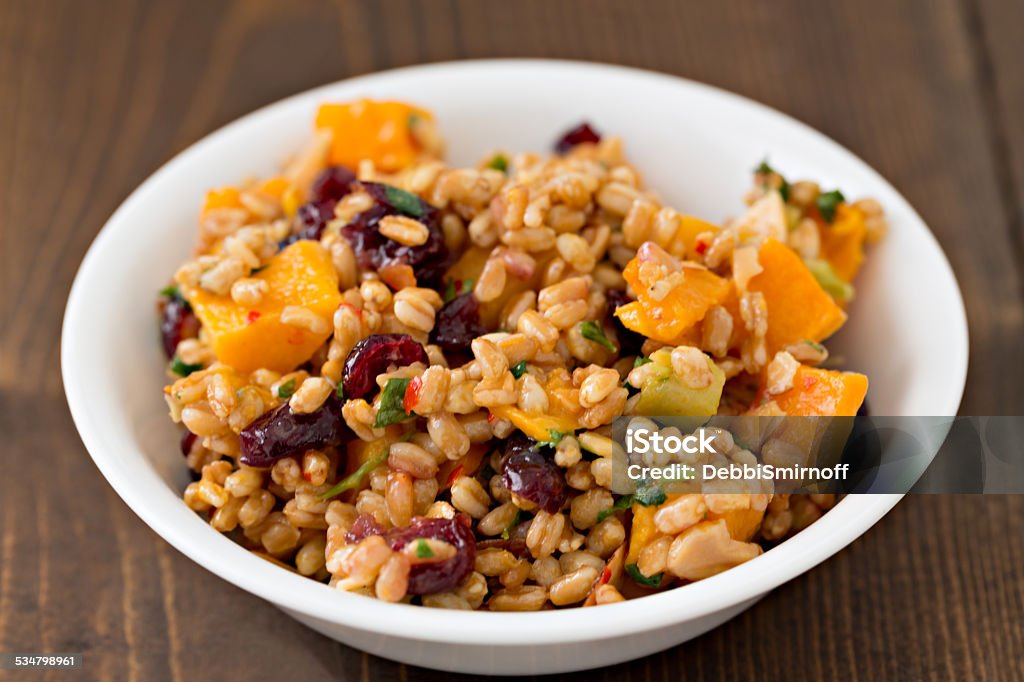 Farro And Butternut Salad A high angle extreme close up horizontal photograph  of a bowl full of Farro wheat butternut salad Farro Stock Photo