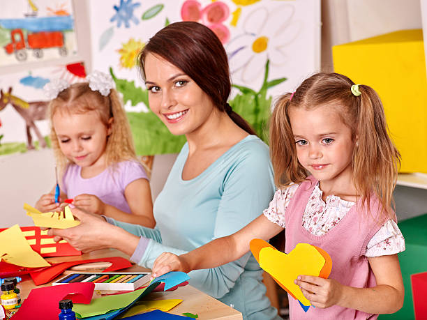 istock Children with teacher painting 534799611