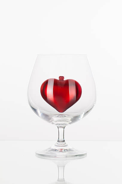istock Red heart inside a glass of cognac 534801289