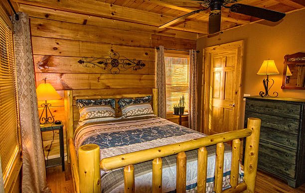 camera da letto nel log cabin - cabin indoors rustic bedroom foto e immagini stock