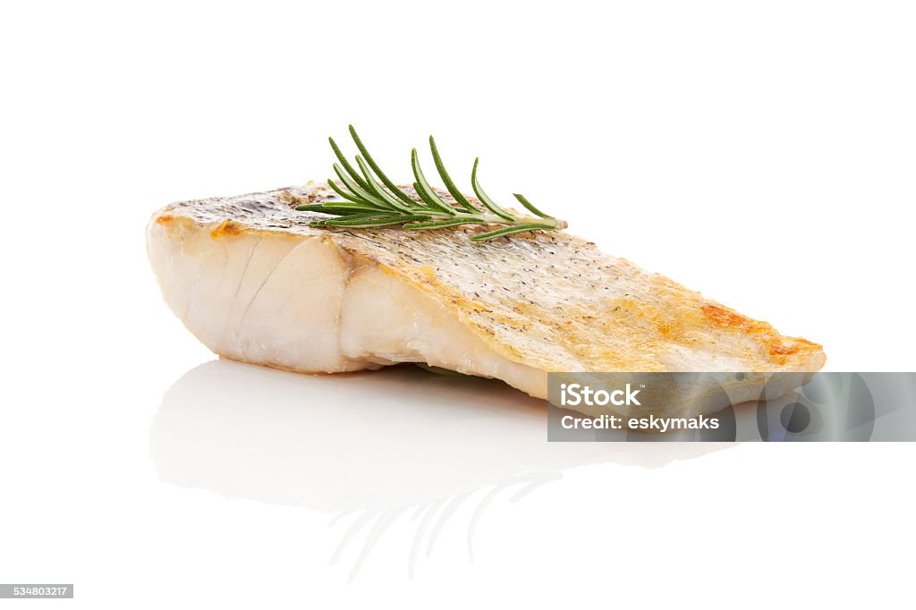 Luxurious seafood dinner. Luxurious seafood dinner. Perch fish fillet isolated on white background with fresh green herbs. Healthy eating. Fish Stock Photo