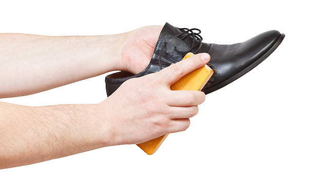 istock Shoeshiner brushing black shoe by brush 534804151