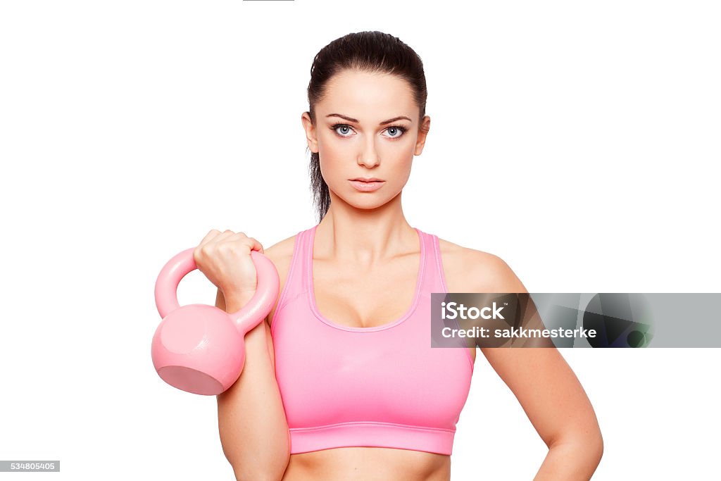 Young sporty woman with kettlebell Young sporty woman with kettlebell portrait, isolated on white Kettlebell Stock Photo