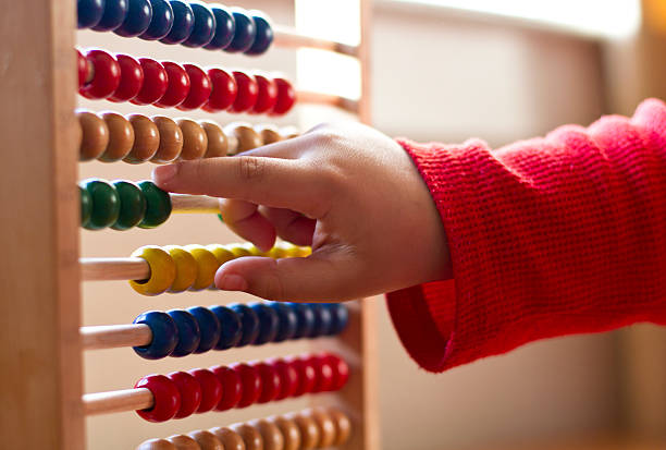 Child learning counts on Abacus stock photo
