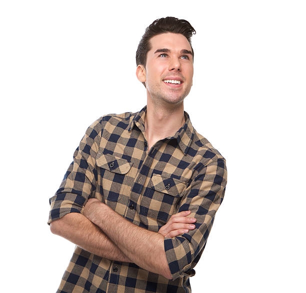 istock Close up smiling young man with arms crossed looking up 534806515