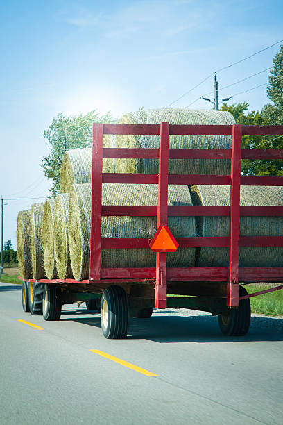 istock Tractor Pulling A Wagon Of Hay On A Country Road 534824171