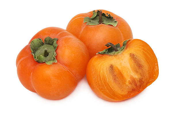 istock Two whole and a half of ripe persimmon (isolated) 534826387