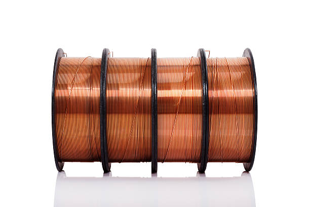 Copper welding wire in spools isolated Copper welding wire wounded on the spools isolated on white. Wire rolls. copper cable stock pictures, royalty-free photos & images