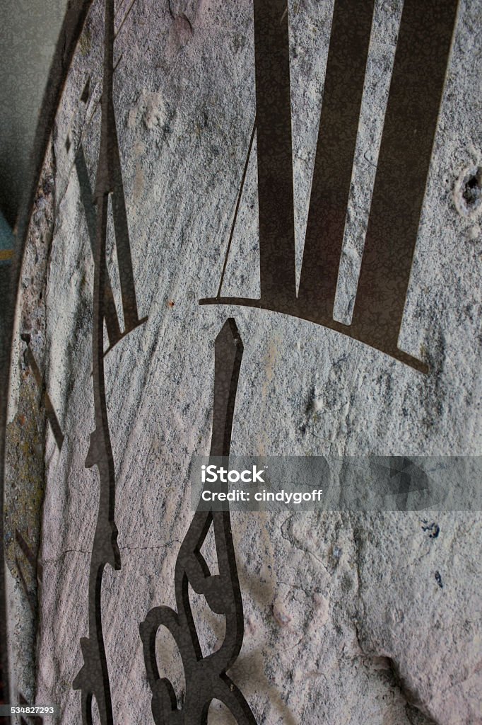 Close-up of clock with black hands and numbers showing midnight  Close-up of clock with rough stone texture black hands and numbers showing midnight 12 O'Clock Stock Photo