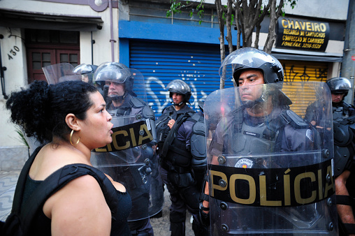 São Paulo, Brazil, January, 09, 2015: Woman facing the police riot in act for the reduction of transport tariffs in Consolação Avenue