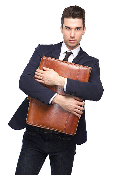 istock Young business man holding leather suitcase 534828015