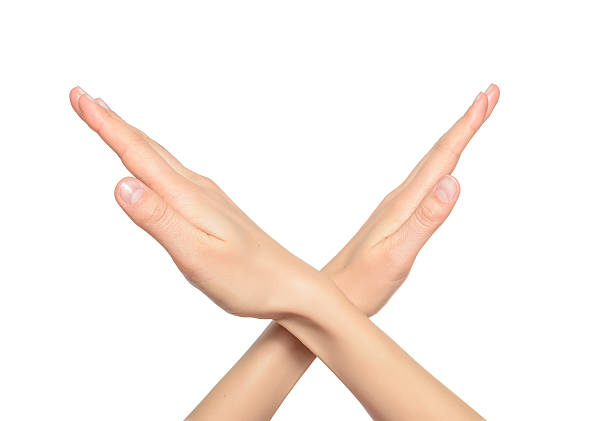 istock Female crossing hands forming an x 534828561