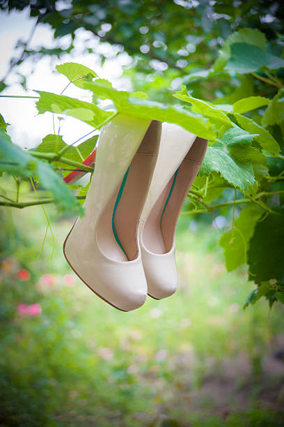istock Womens shoes with high heels are hanging 534828629