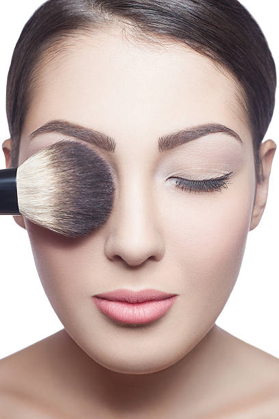 istock Beautiful young woman closing eyes with makeup brush 534828795