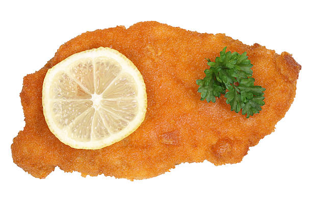 Schnitzel chop cutlet with lemon from above Schnitzel chop cutlet with lemon from above isolated on a white background schnitzel stock pictures, royalty-free photos & images