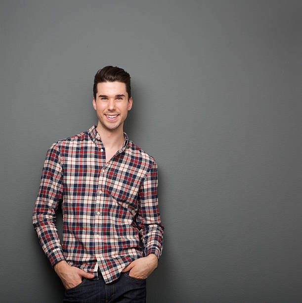 istock Charming young man in checkered shirt smiling 534831185