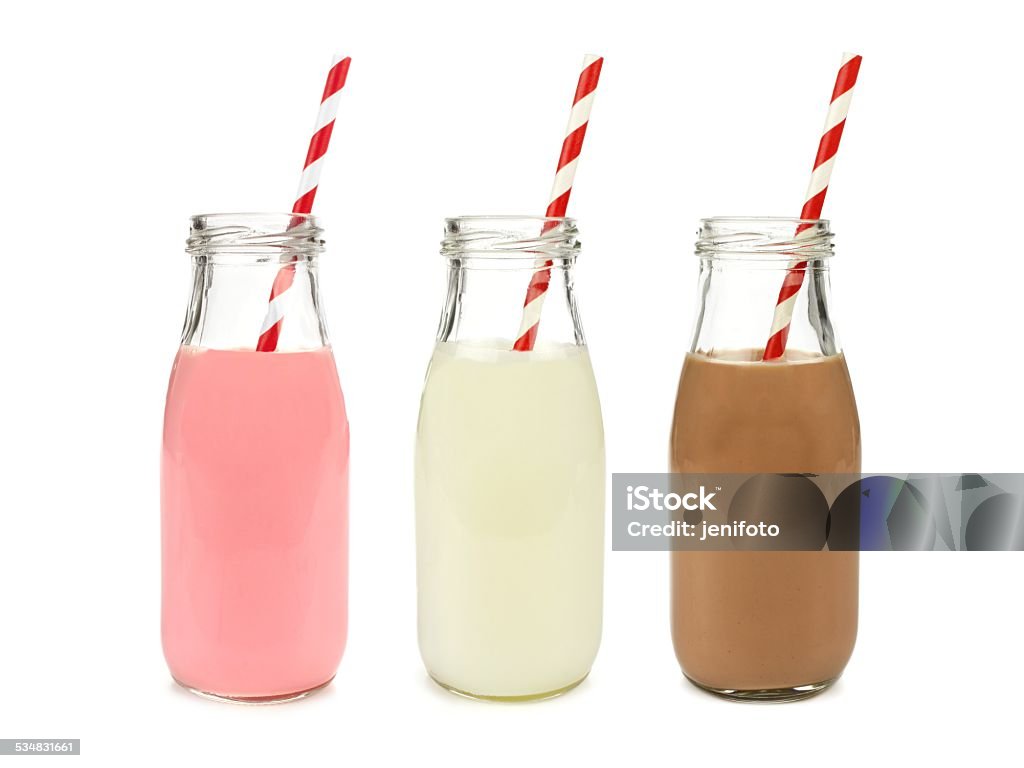 Strawberry regular and chocolate milk in bottles, isolated Strawberry regular and chocolate milk in bottles with striped straws isolated on white Chocolate Milk Stock Photo