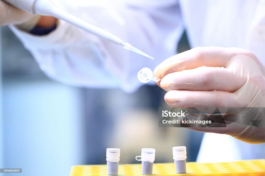 Scientist Hand Using A Pipette Close-up of scientist hand using a pipette for experiment. 2015 Stock Photo