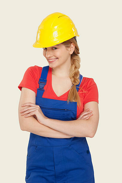 istock Young woman wearing hard hat smiling 534843459