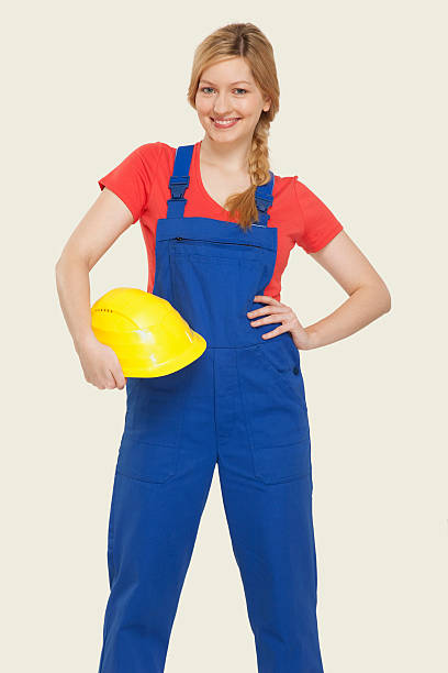 Young woman holding hardhat smiling