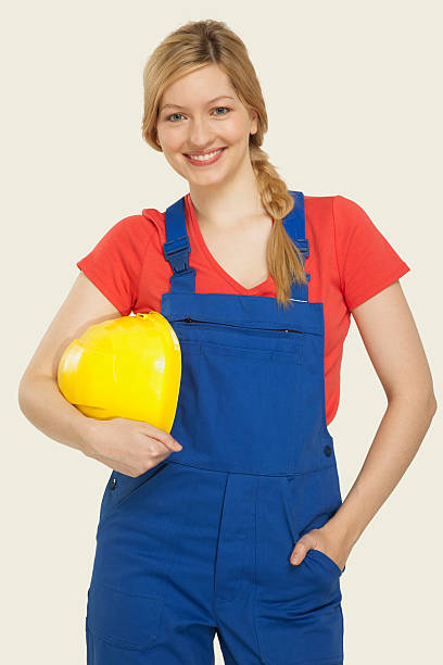 istock Young woman holding hardhat smiling 534843467