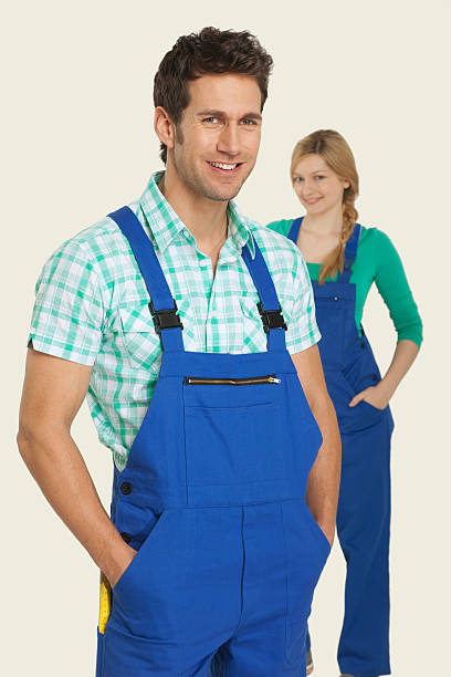 istock Man and woman in overall smiling 534843739