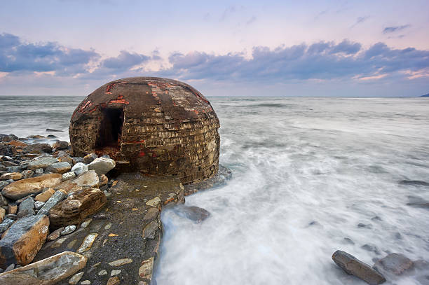 ruins of abandoned bunker on Azkorri beach at sunset