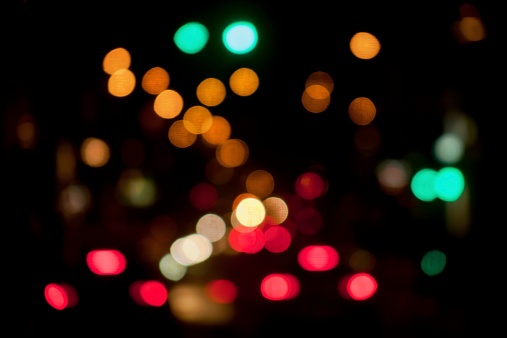 Bokeh night city lights, traffic lights and street lamps. Abstract image suitable for city life or traffic background.