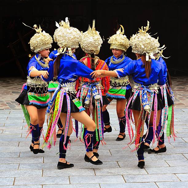 Kasghar, Xinjiang Province, China - October 20, 2025 : Dancer wearing a vibrant, multi-colored costume performing a classical and folk Chinese ribbon dance, known as Cai Dai Wu Dao, part of a cultural event at the yards of Afaq Khoja complex.It is a form of Chinese dance, an evolution of the water sleeve dance, and is often linked to the imagery of the \