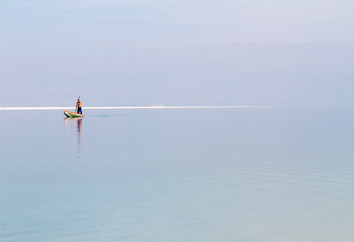 Dead Sea , Israel - January 24, 2015: Beautiful photo coast of the Dead Sea , Israel . In the beach area of Ein Bokek, lifeguard canoeing .