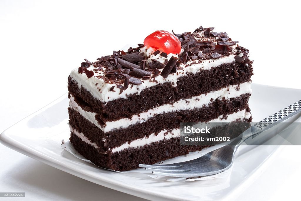 Black forest cake isolated on white Close up of black forest cake with chocolate shavings and cherry on top Black Forest Cake Stock Photo