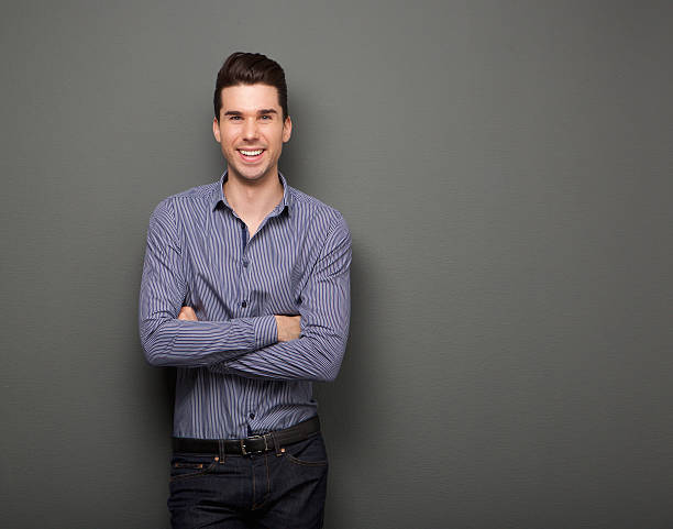 istock Happy young man standing with arms crossed 534864011