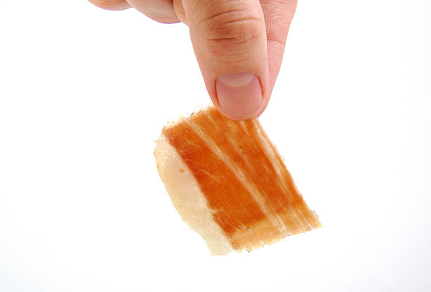istock Man holding a serrano ham slice. Jabugo. Spanish tapa 534865127