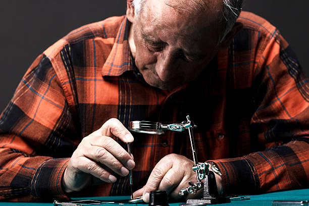 istock Senior man repairing old pocket watch 534866029