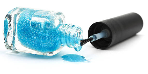 istock bottle and puddle of blue nail polish 534868021